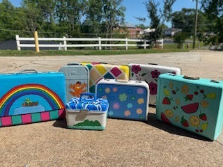 art club painted suitcases